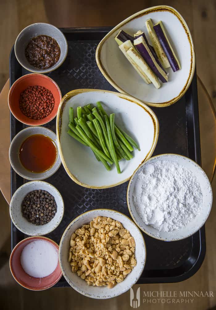 Ingredients to make kare kare in bowls 