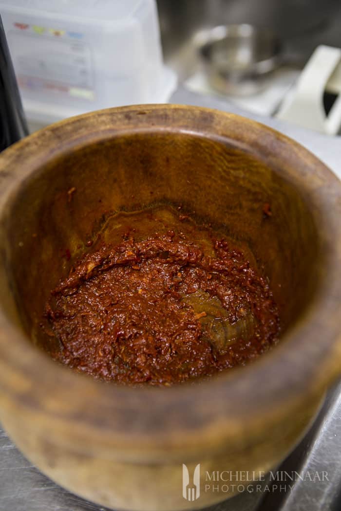 Crushing peppers with mortal and pestle