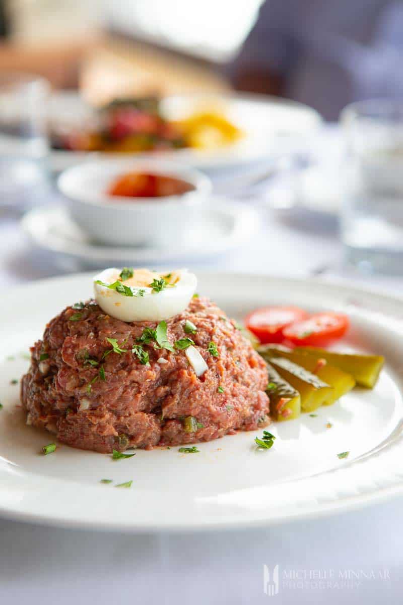 Close up of steak tartare with a boiled egg on top 