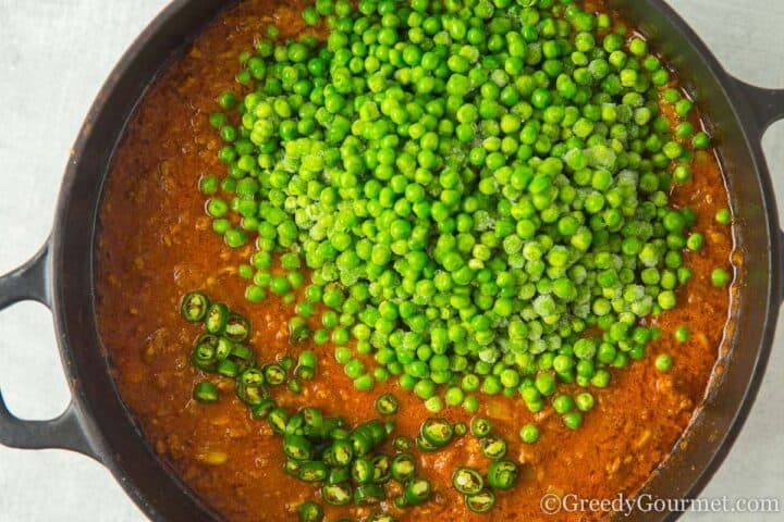 adding peas to pan.