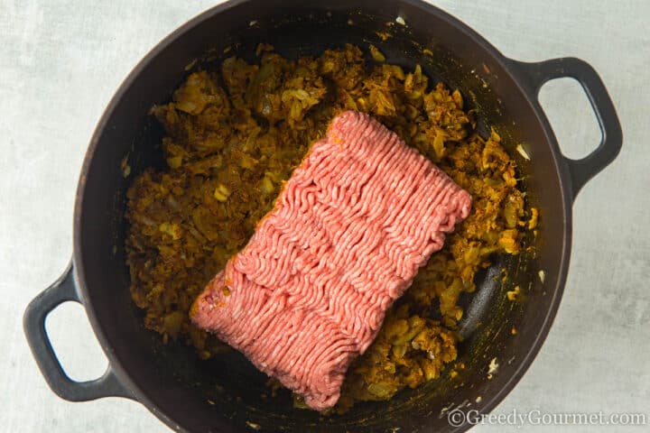 add lamb mince to onion and spices.