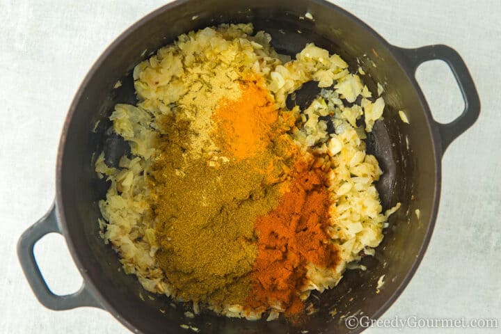 adding spices to onions.