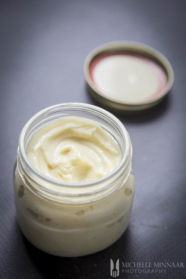 A clear jar full of avocado oil mayonnaise 