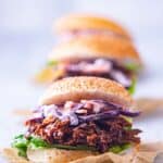 A pulled lamb slider on a seeded bun