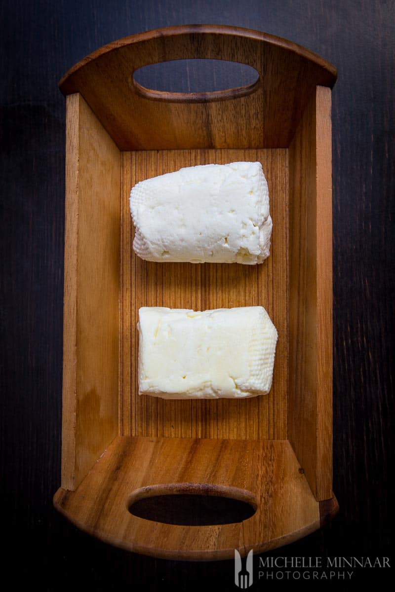 Soaked Vs Straight Halloumi cheese blocks in a wooden box