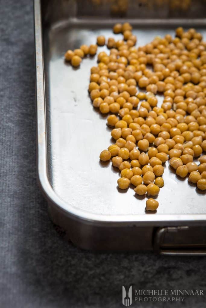 Oiled chickpeas heading for oven Cooked Chickpeas covered in oil