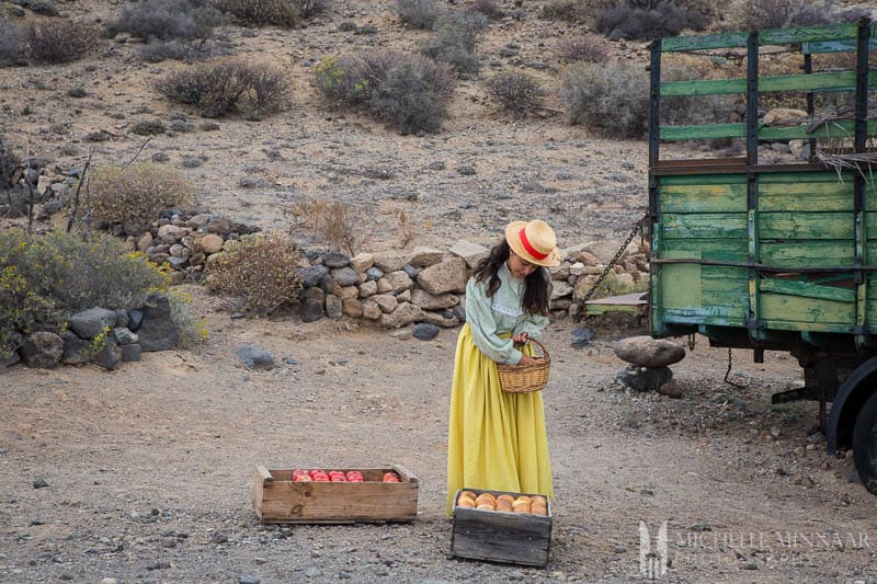 Woman selling tomatoes and apples