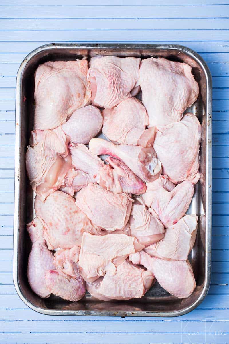 Raw chicken pieces in a pan 