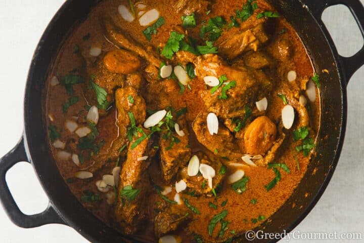 garnish Lamb Chop Curry with coriander and almonds.