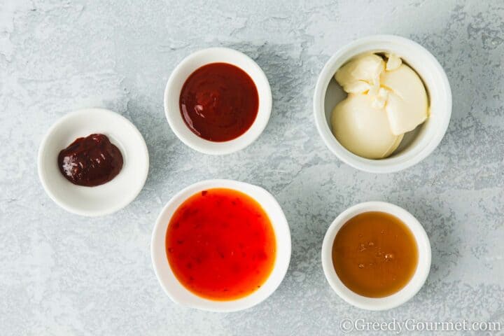 Sauces in small pots on a table.