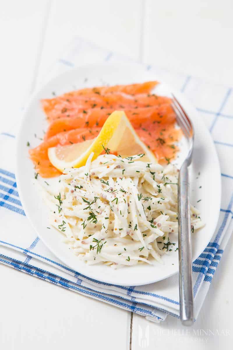 A close up of celeriac remoulade, smoked salmon and a fork