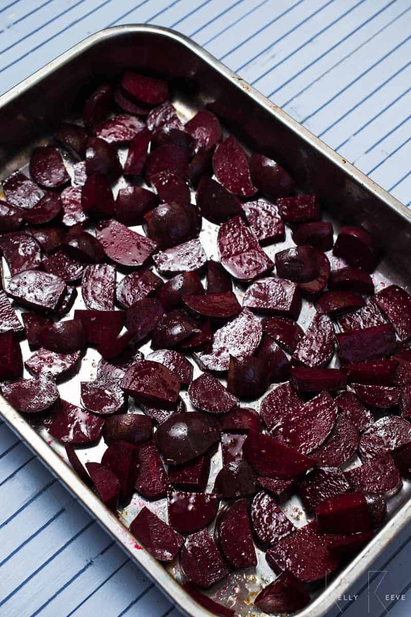 Raw beets in a pan waiting to be roasted