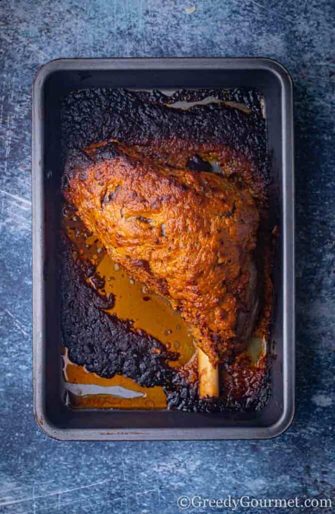 Marinated leg of lamb in a pan 