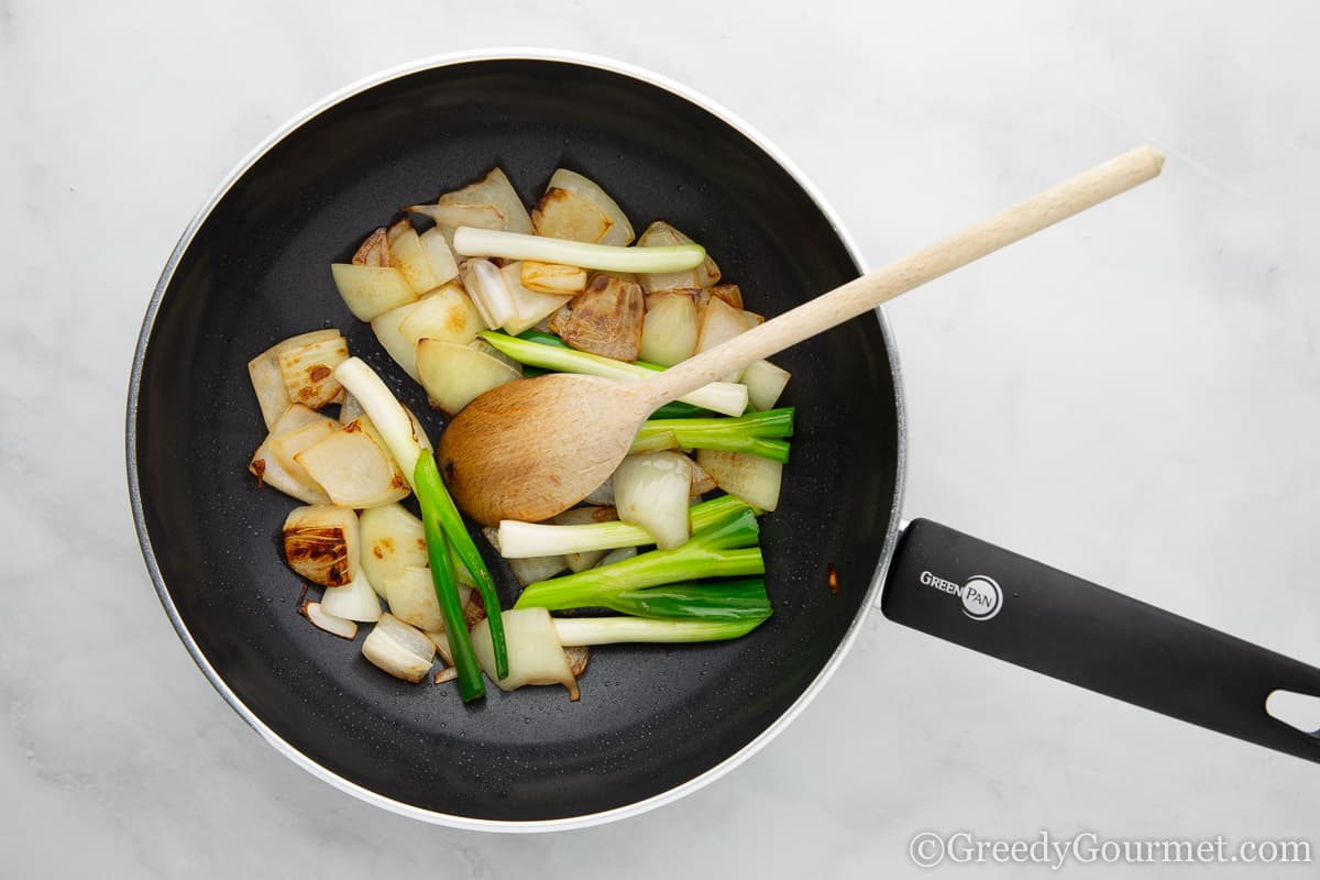 Vegetables being sauteed in a wok