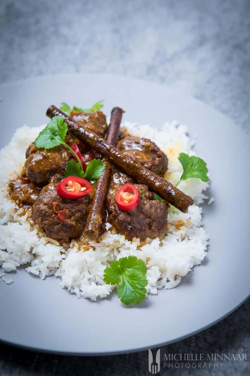 A plate of white rice and beef kofta on top 