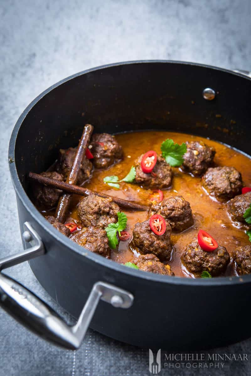 A close up of Beef Kofta Curry, meatballs in a  brown sauce