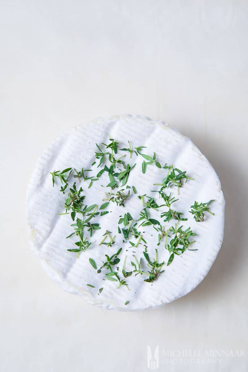 Camembert cheese with thyme on top.