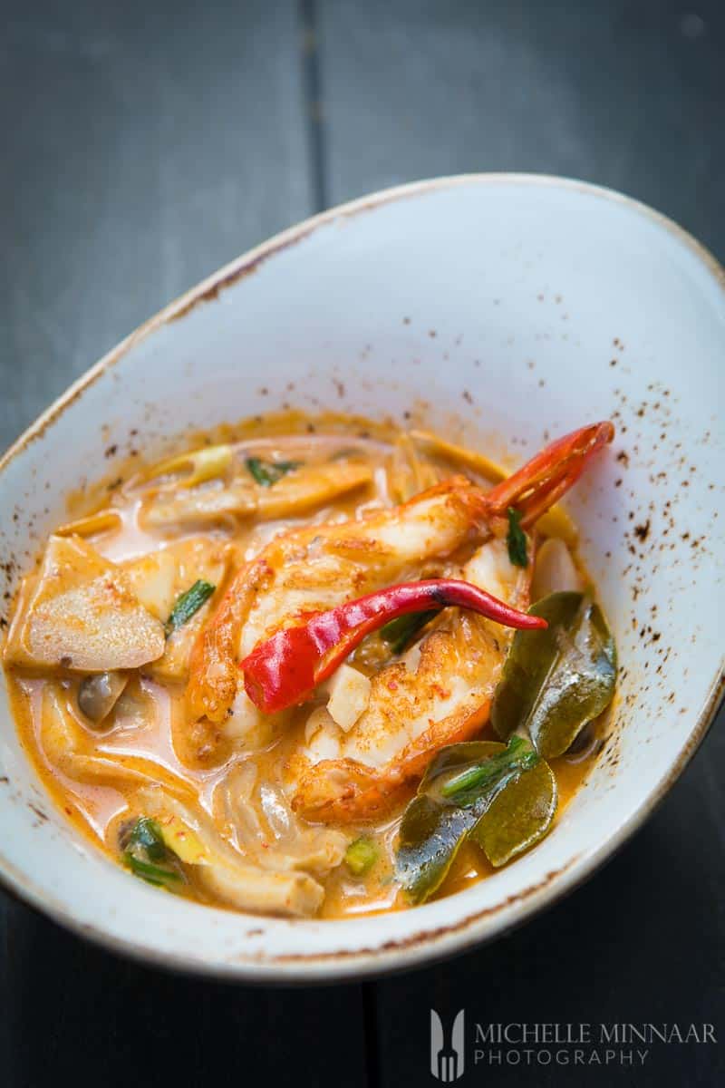 Tom Yum Goong in a white bowl