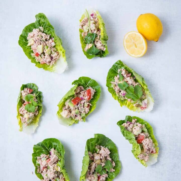 7 Tuna Lettuce Wraps and two lemons on a counter