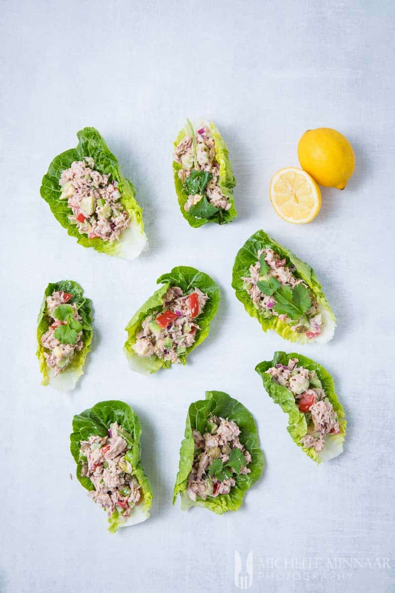 7 Tuna Lettuce Wraps and two lemons on a counter