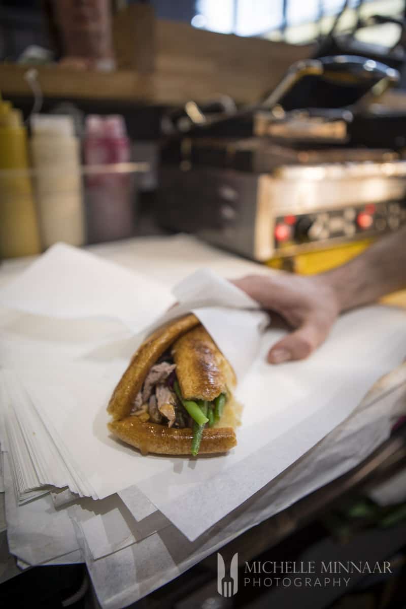 A large sandwich served in white paper