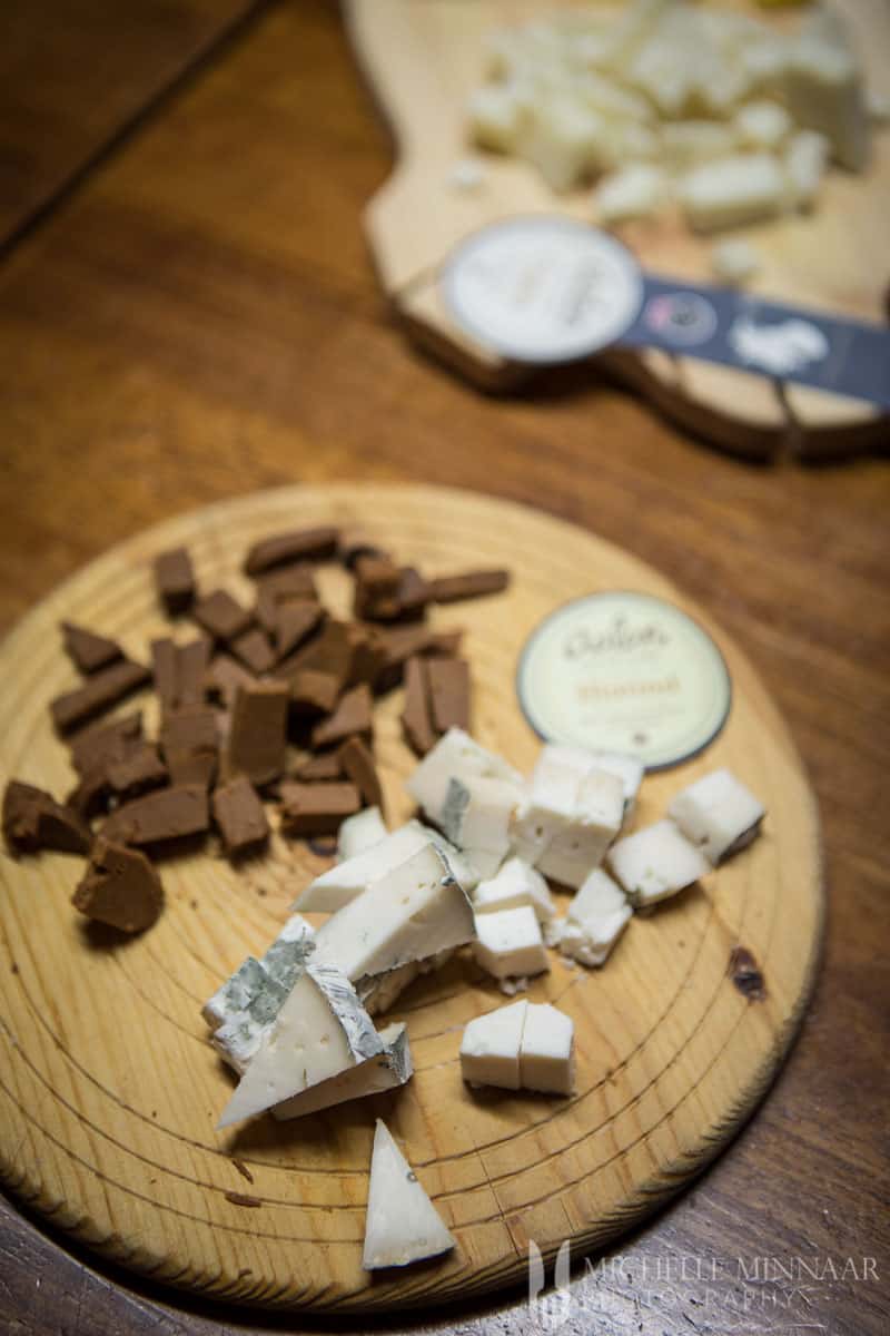 Brie cheese and chocolate on a wooden cutting board 
