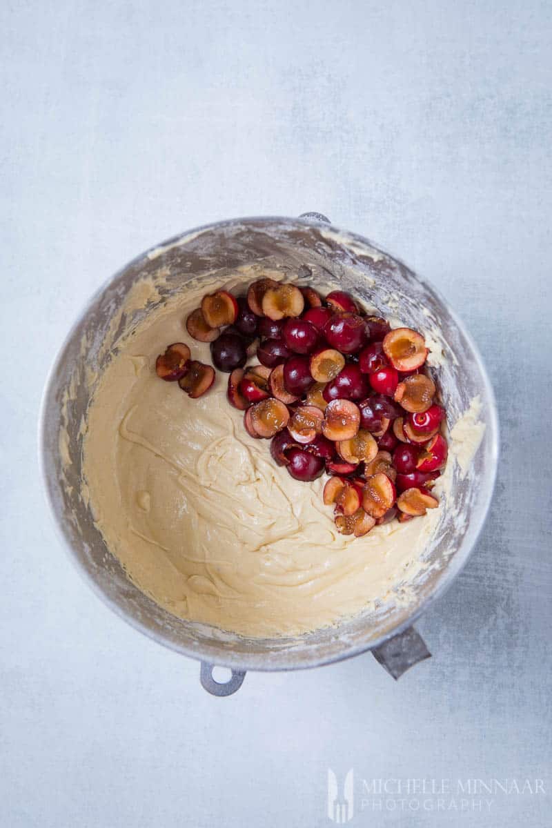 Cut up cherries and wet cake better in a bowl for cherry muffins