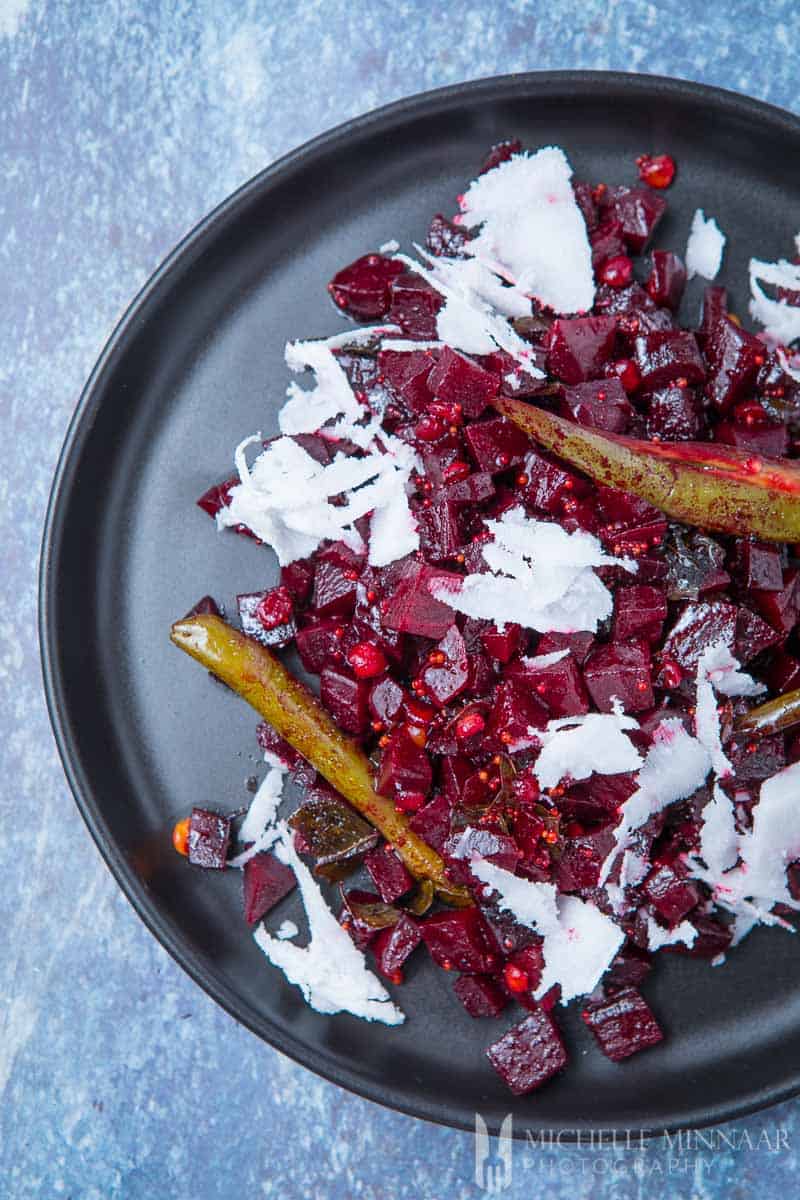  Beetroot Poriyal - a plate of beets with coconut shavings