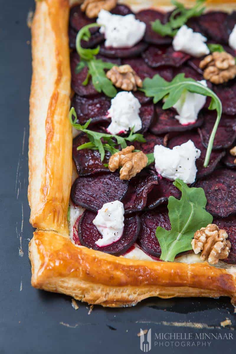 A close up of goat's cheese and beetroot tart