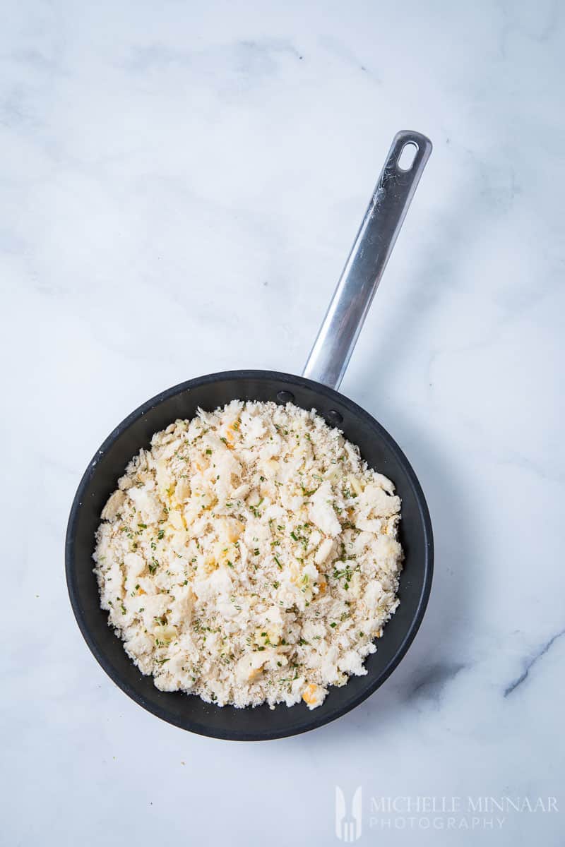 A skillet pan full of Breadcrumbs for Pangritata