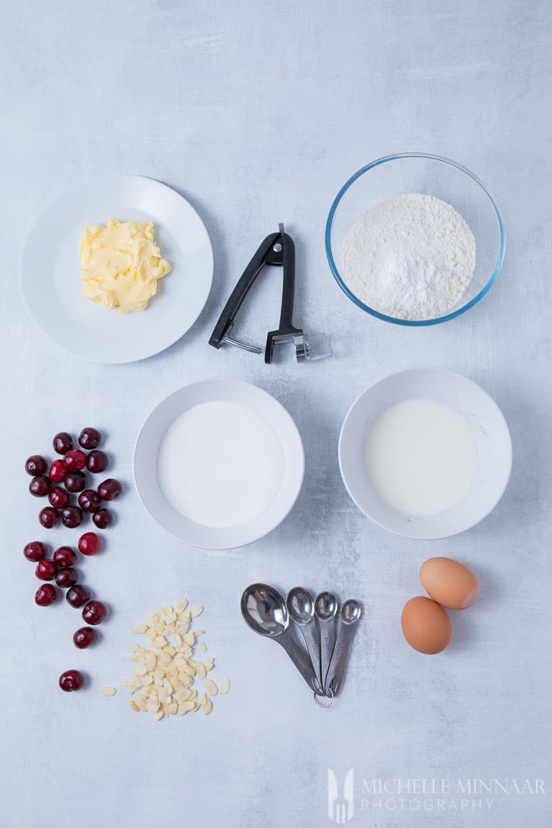 Ingredients for Cherry Muffins: Milk Sugar Flour Almond Cherries Butter