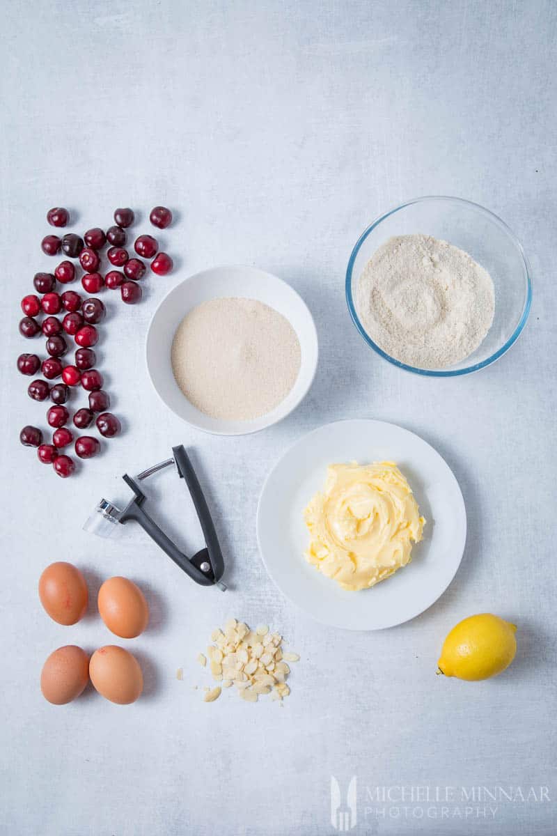 Ingredients to make a cherry bakewell cake: Almonds Cherry, butter, egg, flour