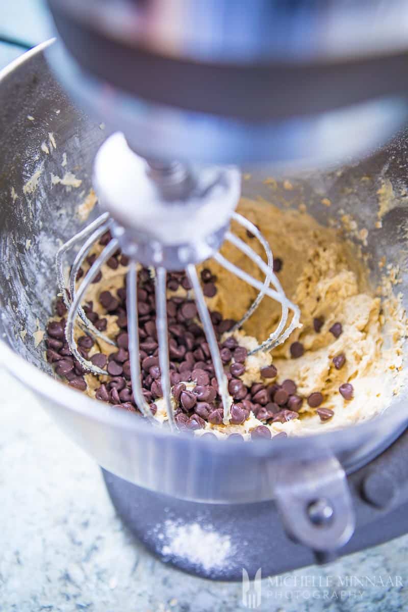 Batter in a blender mixing to make sugar free chocolate chip cookies