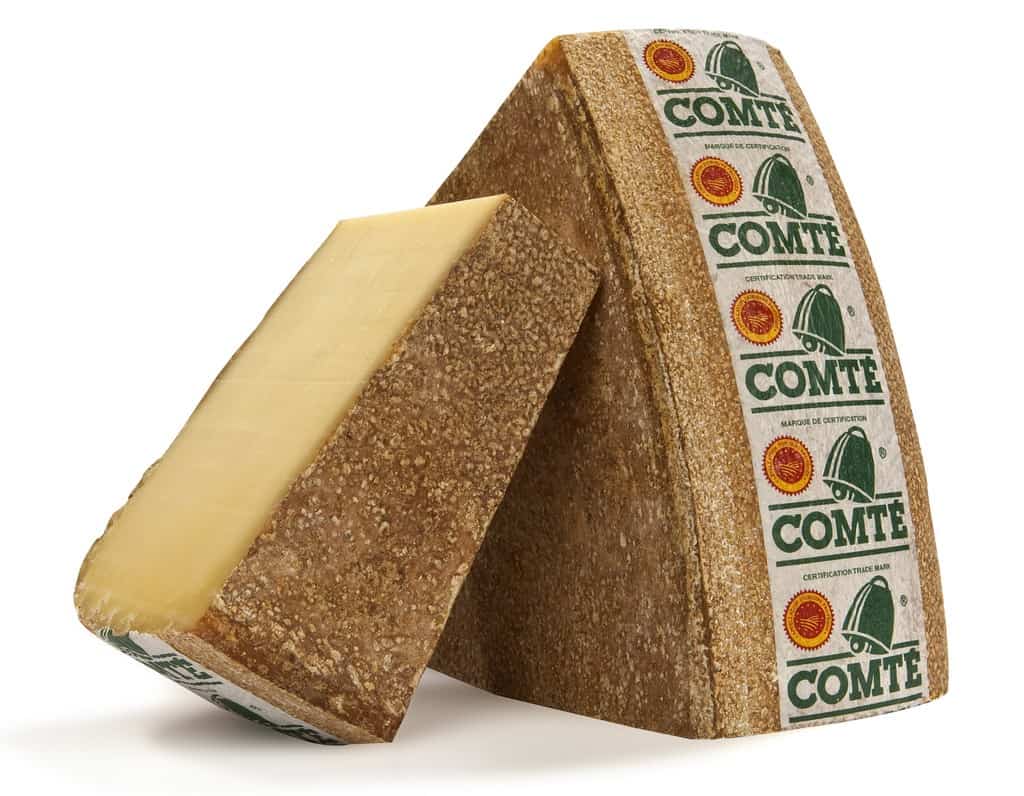 Two blocks of comte cheese standing up as a manchego cheese substitutes