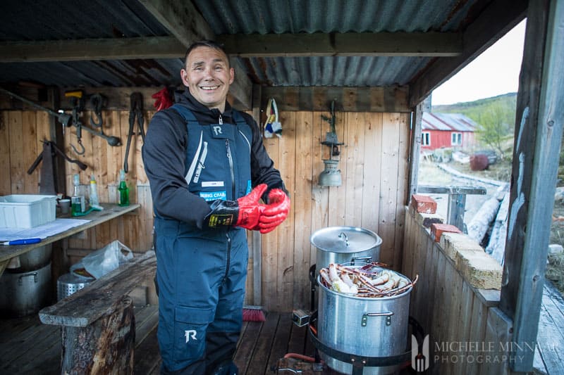 A smiling Fisherman preparing steamed crab legs