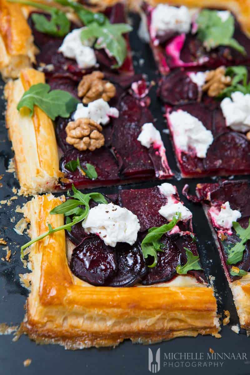 A close up of goat's cheese and beetroot tart