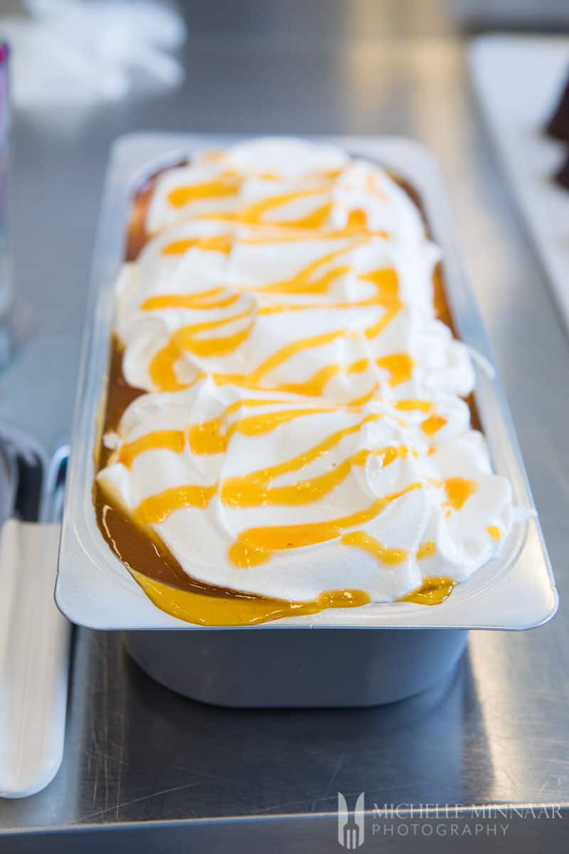 A close up of gelato with orange sauce