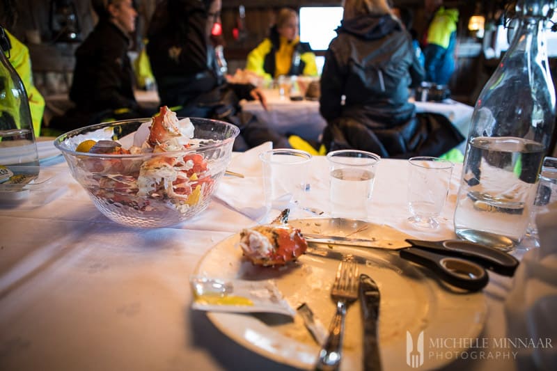 A view from the table with plates and scissors to cut open the crab leg from the King Crab Safari 