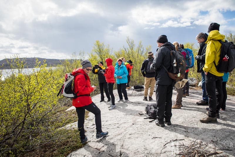 A group of people standing on a rock 