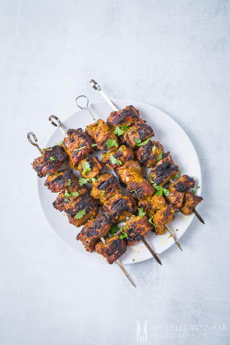 A plate of lamb tikka - lamb on skewers