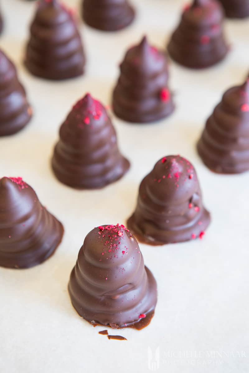 Chocolate truffles in a cone shape with red sprinkles 