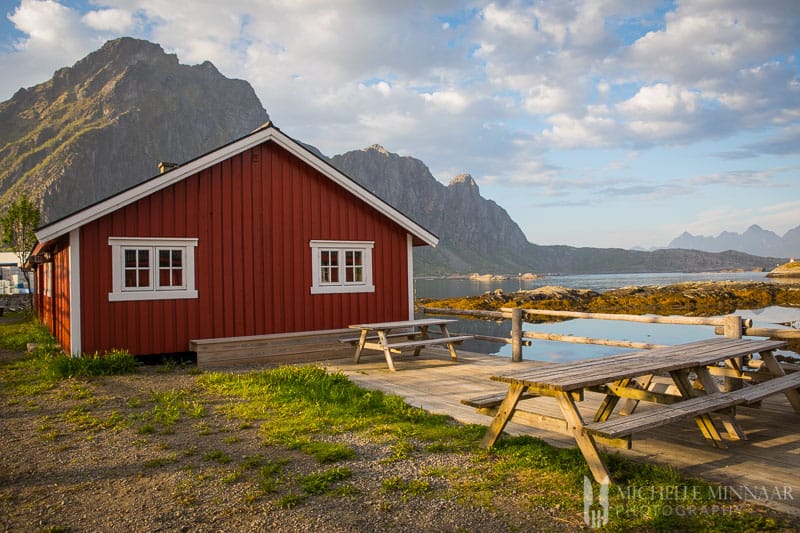 A red cabin and picnic tables 