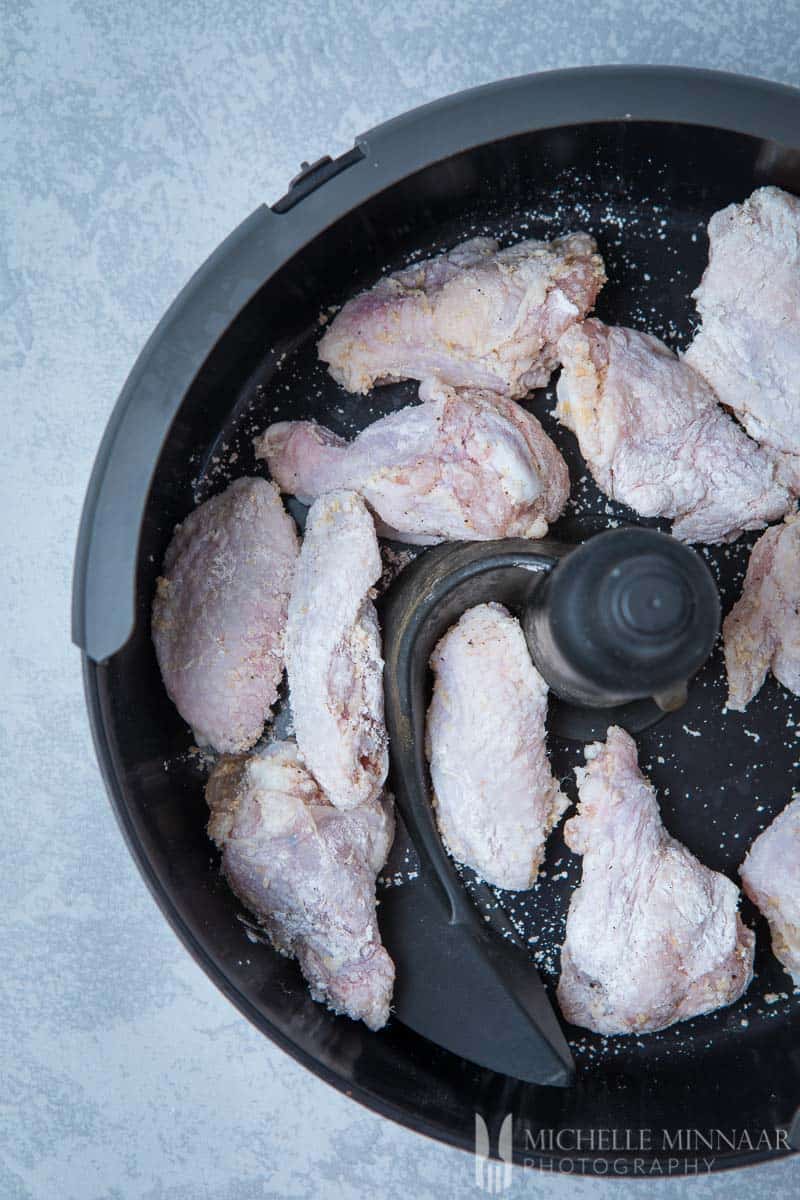 Raw chicken wings in an air fryer
