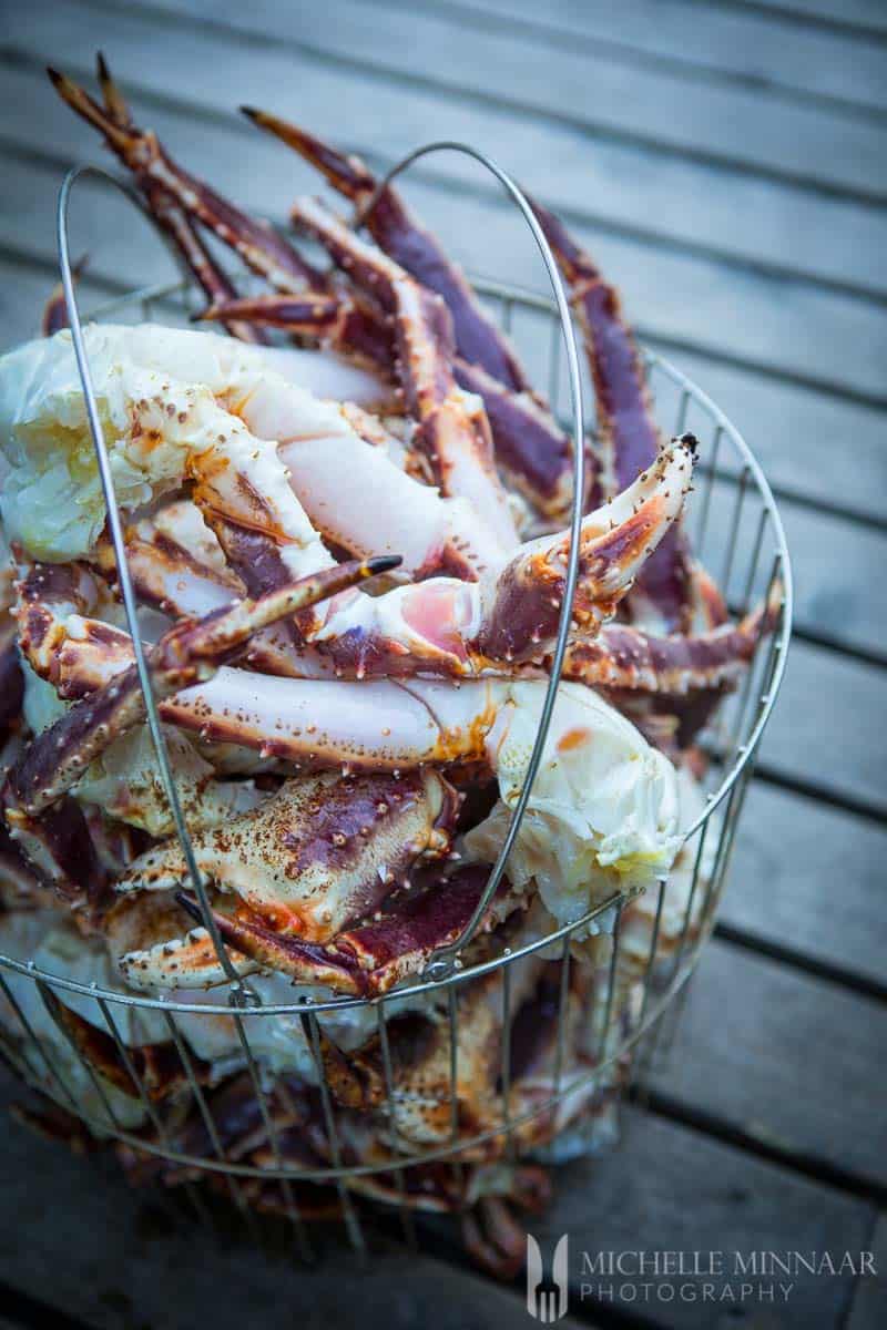 A close up view of crab legs in a basket 