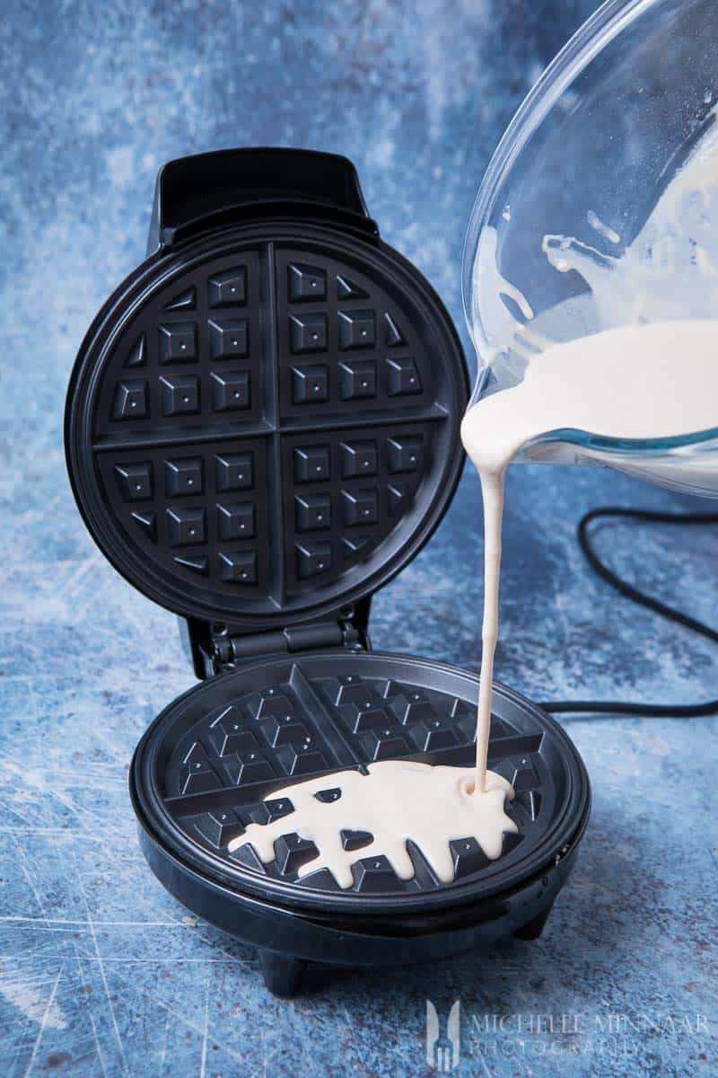 Batter being poured onto a waffle iron 