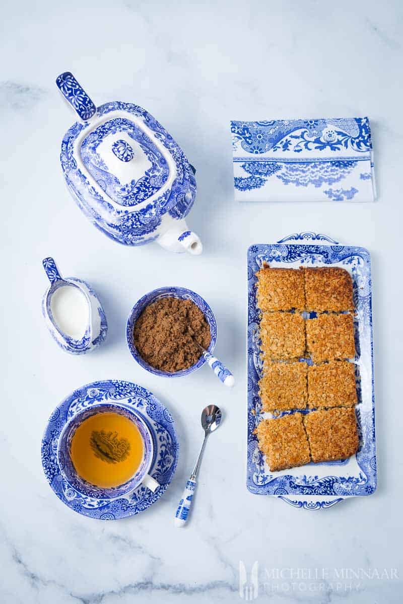 A plate of Sugar Free Flapjacks and a cup of tea and a teapot