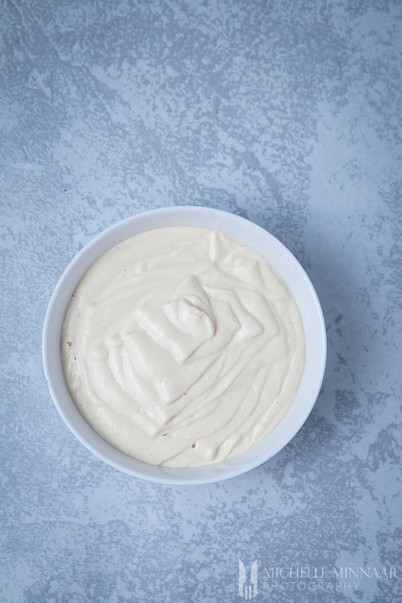 A bowl of Vegan Cashew May to make vegan coleslaw