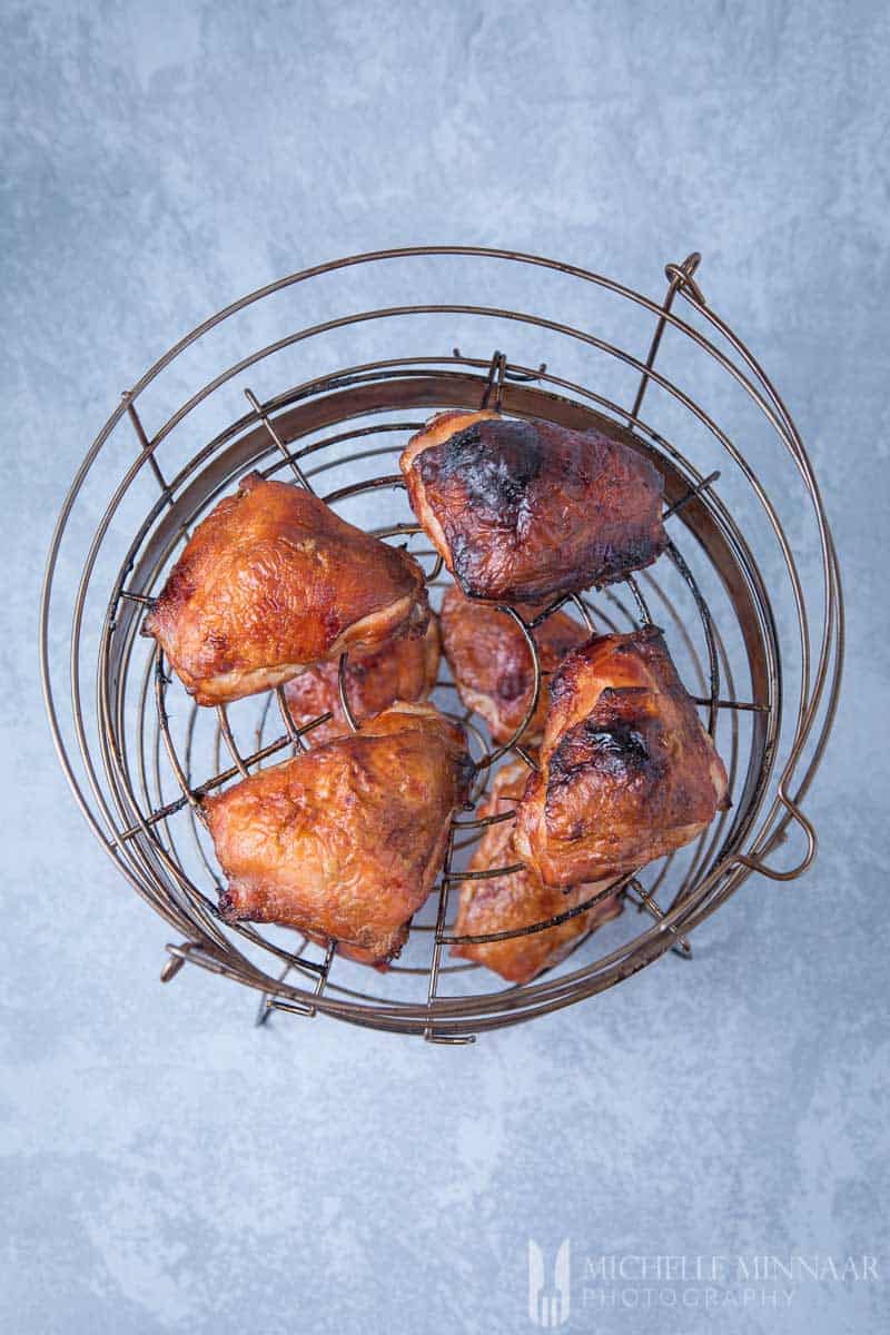 A basket of cooked brined chicken thighs