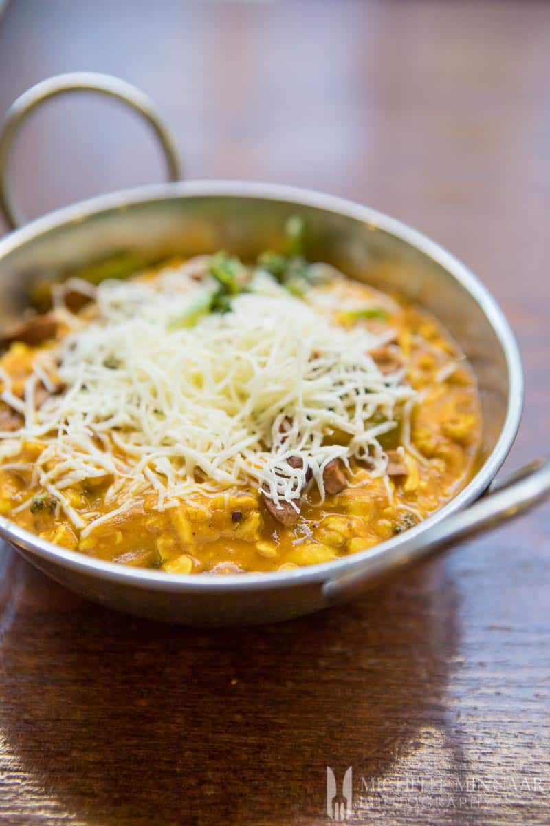 Paneer Gujarati - a bowl of cheese and vegetables