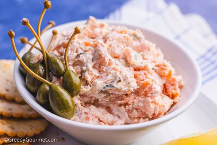 Smoked salmon dip in a bowl with olives.